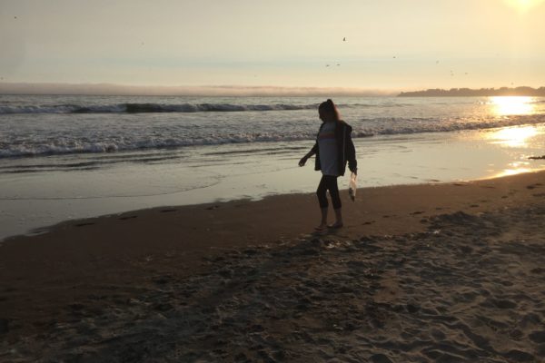 Maegan walking on the beach at sunset