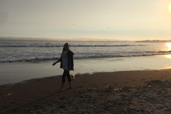 Maegan walking on the beach at sunset