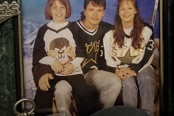 framed photo of Maegan, her mom Stacey, and Dallas Stars right wing Todd Harvey